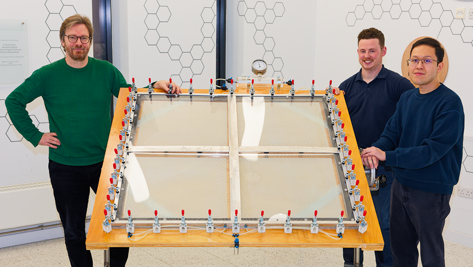 Prof. Erwin Reisner, Ariffin Mohamad-Annuar and Shaun Impey stand behind the solar reactor that Shaun built